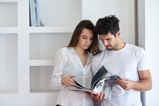 romantic happy young couple relax at modern home staircase indoors