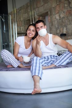 happy young couple relax and have fun in bed