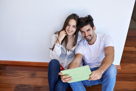 romantic relaxed young couple at modern home using tablet computer