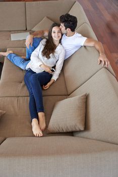 happy young romantic couple have fun relax smile at modern home livingroom indoors