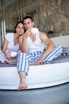 happy young couple relax and have fun in bed