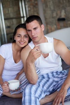 happy young couple relax and have fun in bed