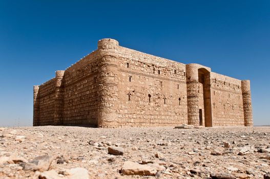 ancient desert castle with blue sky in background in Jordan