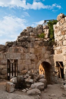 ruins of the ancient castle with blue cloudy sky in background