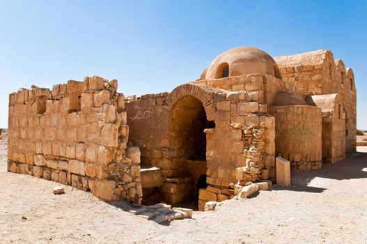 ancient desert ruins in Jordan with blue sky in background