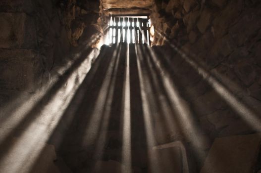 sun rays beaming through the jail window into the cell