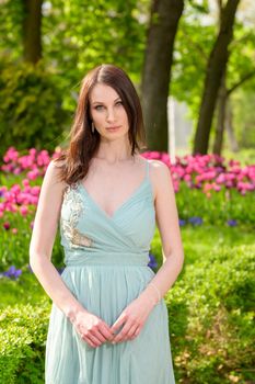 A beautiful young Russian woman in a park in the first warm spring sun.
