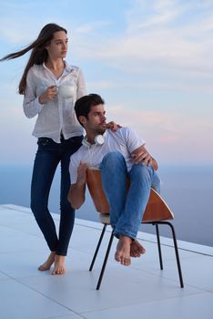 happy young romantic couple have fun relax smile at modern home outdoor terace balcony terace