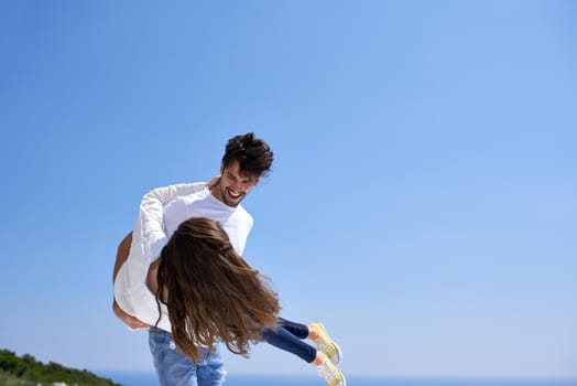 happy young romantic couple have fun relax smile at modern home outdoor terace balcony