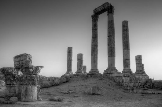 ancient ruins with sun and sunset sky in background (Temple of Hercules in Amman, Jordan)