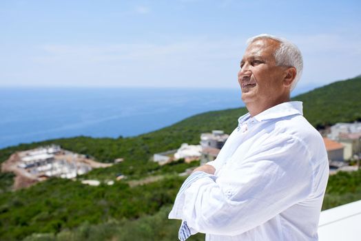 senior man in front of luxury modern home villa