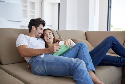 romantic relaxed young couple at modern home using tablet computer