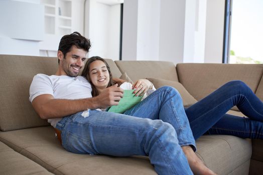 romantic relaxed young couple at modern home using tablet computer