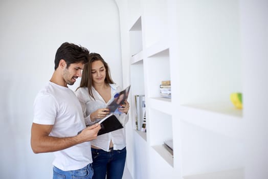 romantic happy young couple relax at modern home staircase indoors