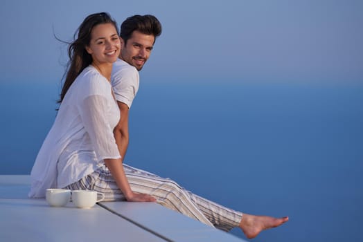 happy young romantic couple have fun relax smile at modern home outdoor terace balcony terace