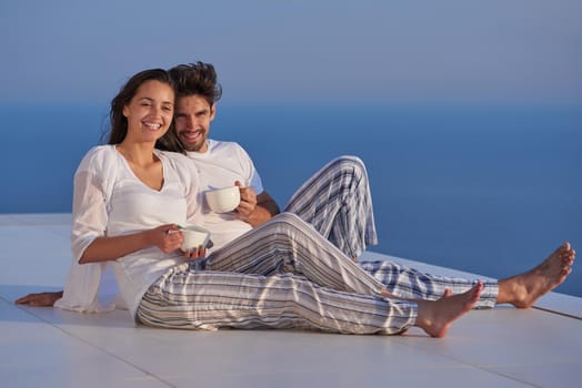 happy young romantic couple have fun relax smile at modern home outdoor terace balcony terace