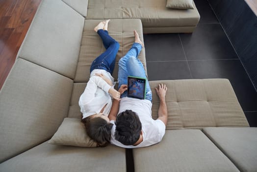 romantic relaxed young couple at modern home using tablet computer