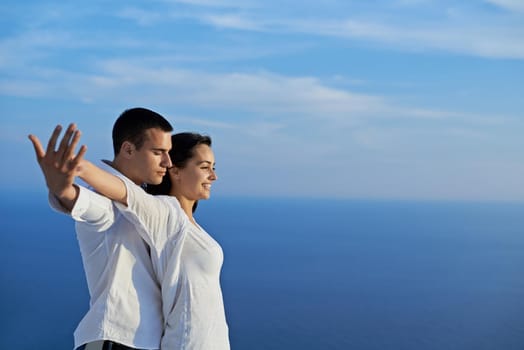 happy young romantic couple have fun relax smile at modern home outdoor terace balcony