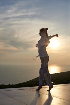 happy young woman enjoy sunset while dancing and enjoy music on headphones