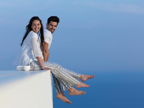 happy young romantic couple have fun relax smile at modern home outdoor terace balcony terace