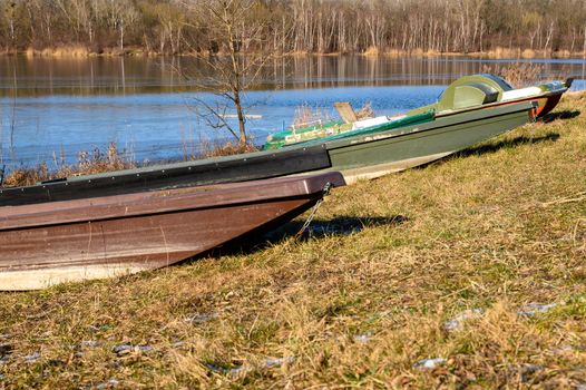 Some abandoned small fishing boats lie on the wintry bank of the Danube.