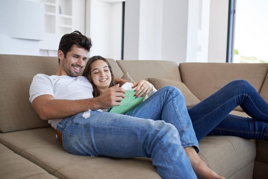 romantic relaxed young couple at modern home using tablet computer