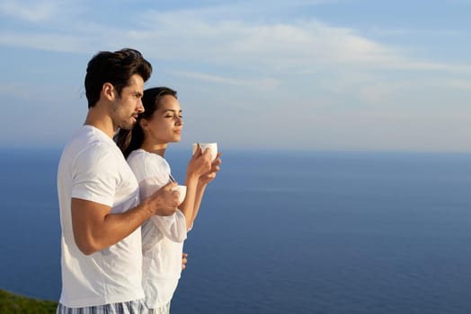 happy young romantic couple have fun relax smile at modern home outdoor terace balcony