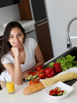 Young Woman Cooking in the kitchen. Healthy Food - Vegetable Salad. Diet. Dieting Concept. Healthy Lifestyle. Cooking At Home. Prepare Food