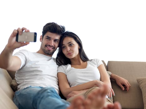 cheerful happy young couple making selfie together at home