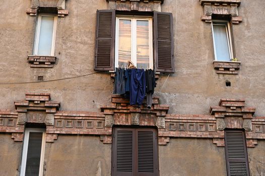 A typical old Italian house with a clothesline between the windows.