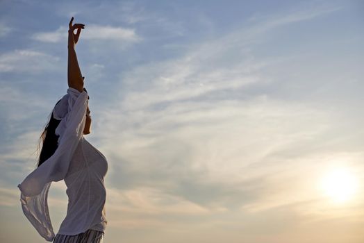 happy young woman enjoy sunset while dancing and enjoy music on headphones