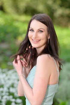 A beautiful young Russian woman in a park in the first warm spring sun.