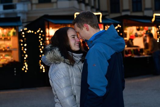 Young couple teasing each other at the Christmas market.