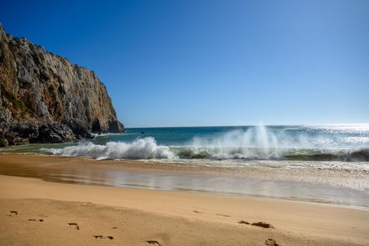 A sandy beach at the Algarve in Portugal with some powerful waves.