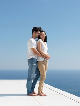 happy young romantic couple have fun relax smile at modern home outdoor terace balcony terace