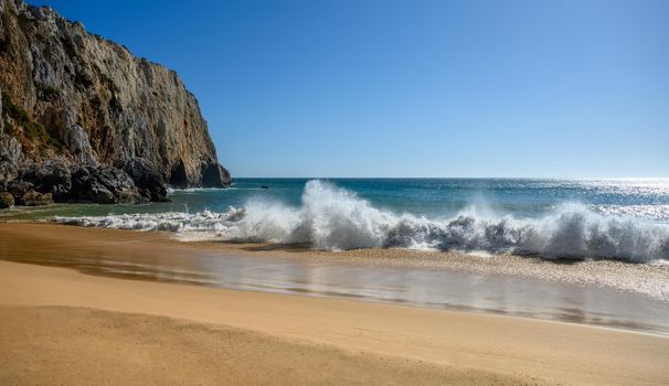 A sandy beach at the Algarve in Portugal with some powerful waves.