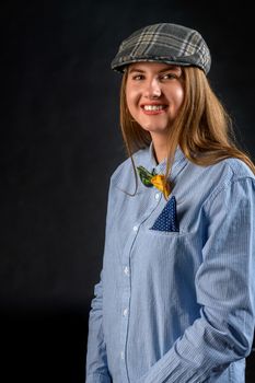 A beautiful young woman with long blond hairs in typically mens outfit.