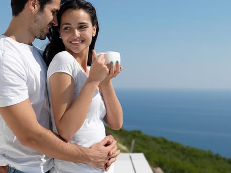 happy young romantic couple have fun relax smile at modern home outdoor terace balcony terace