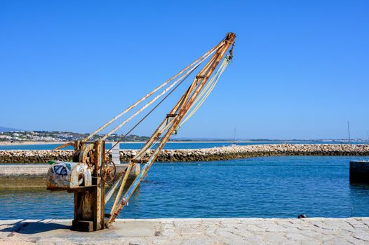 A small old harbor crane as an industrial monument.