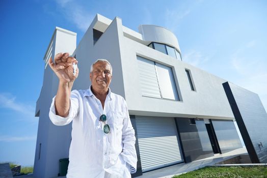 senior man in front of luxury modern home villa