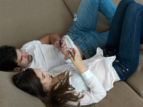 cheerful happy young couple making selfie together at home