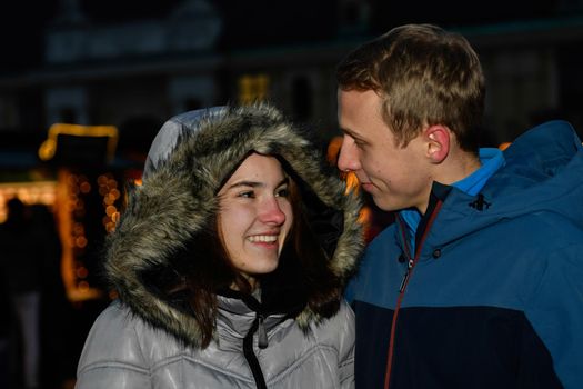 Young couple teasing each other at the Christmas market.