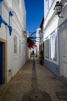 A small narrow alley in a typical small town in Portugal.