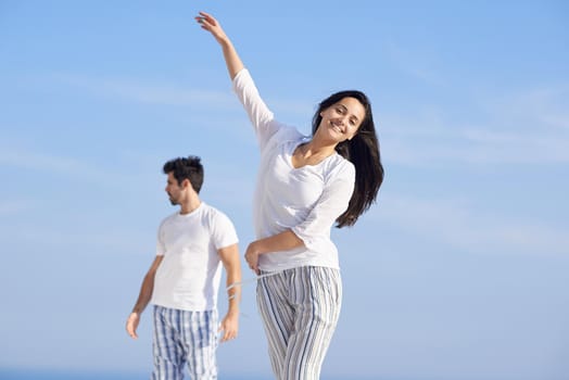 happy young romantic couple have fun relax smile at modern home outdoor terace balcony