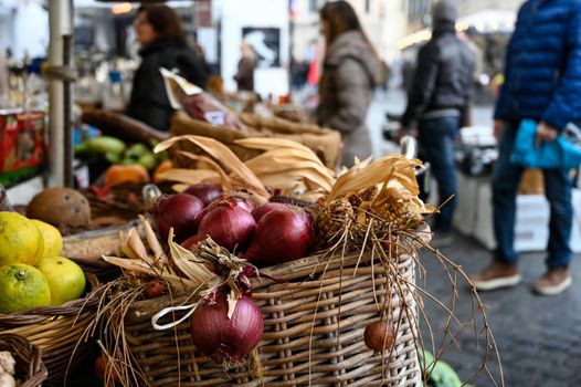 Stalls with chilli and vegetables at a weekly market in Rome.