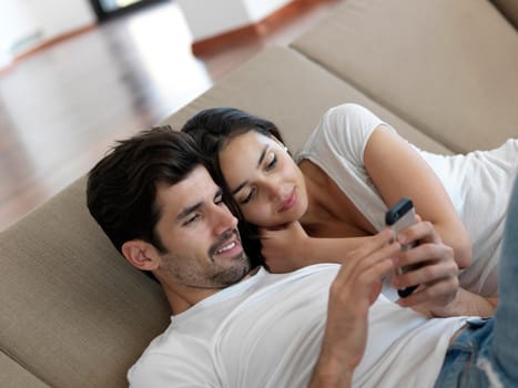 cheerful happy young couple making selfie together at home