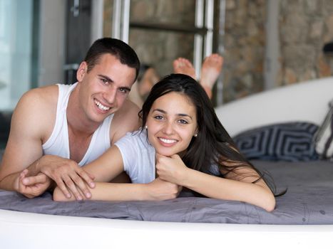 happy young couple relax and have fun in bed