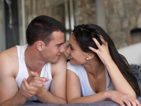 happy young couple relax and have fun in bed