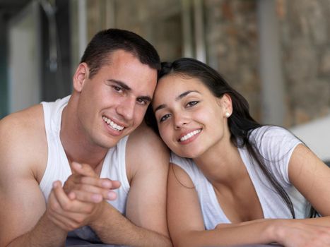 happy young couple relax and have fun in bed