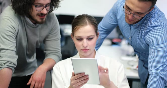 Group of a young business people discussing business plan at modern startup office building